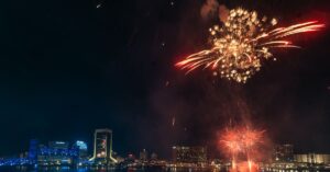 Dazzling fireworks light up the Jacksonville skyline over St. Johns River.